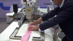 Automatic sewing machine for sewing belts to container bags